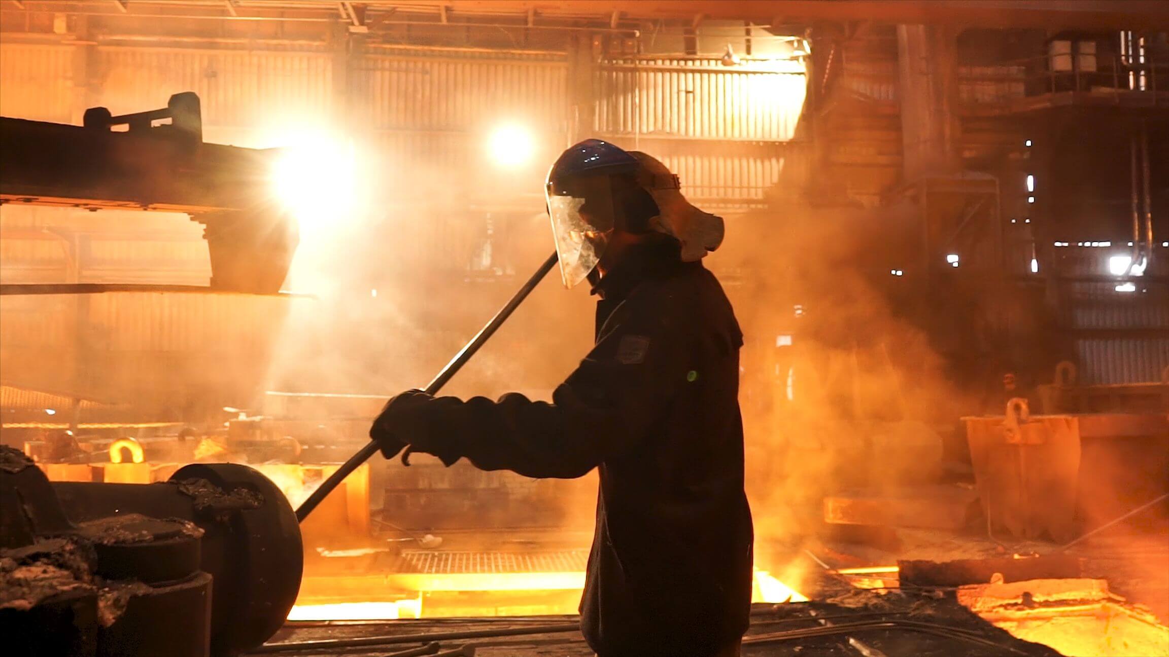 side-view-of-the-оperator-remove-waste-from-furnace